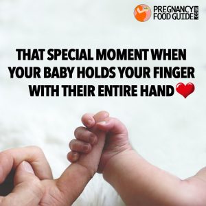 newborn holds finger