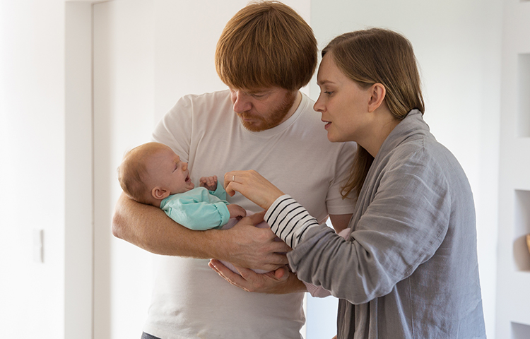 parents soothing crying baby