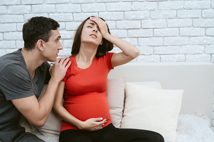 pregnant worried husband consoling