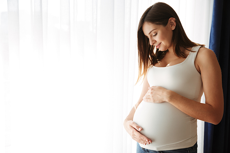 pregnant woman happy touching bump