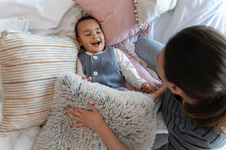 baby mom playing with pillows