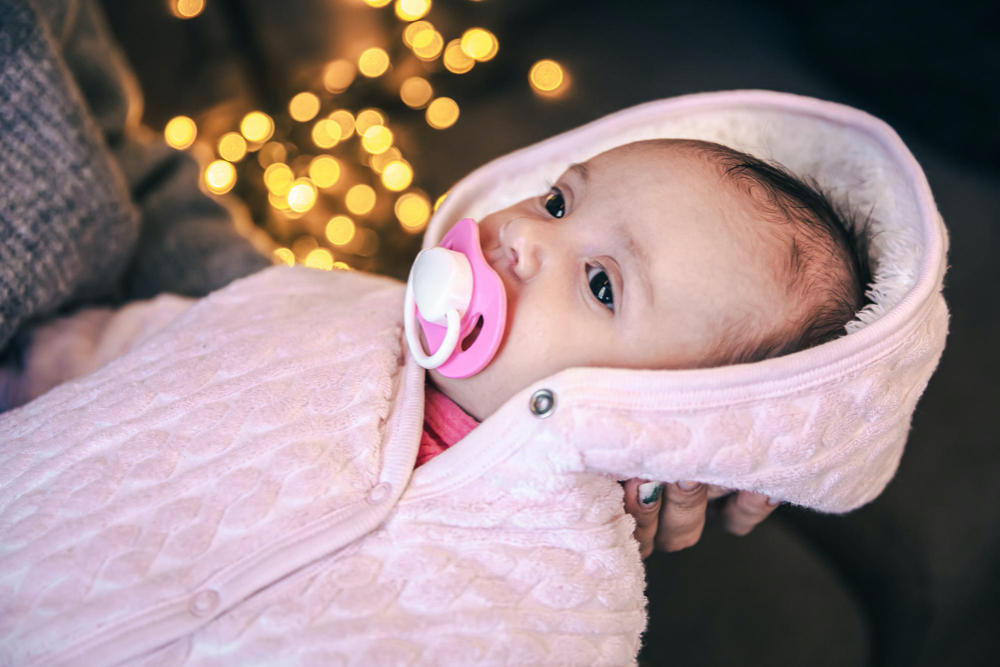 newborn baby girl with pacifier