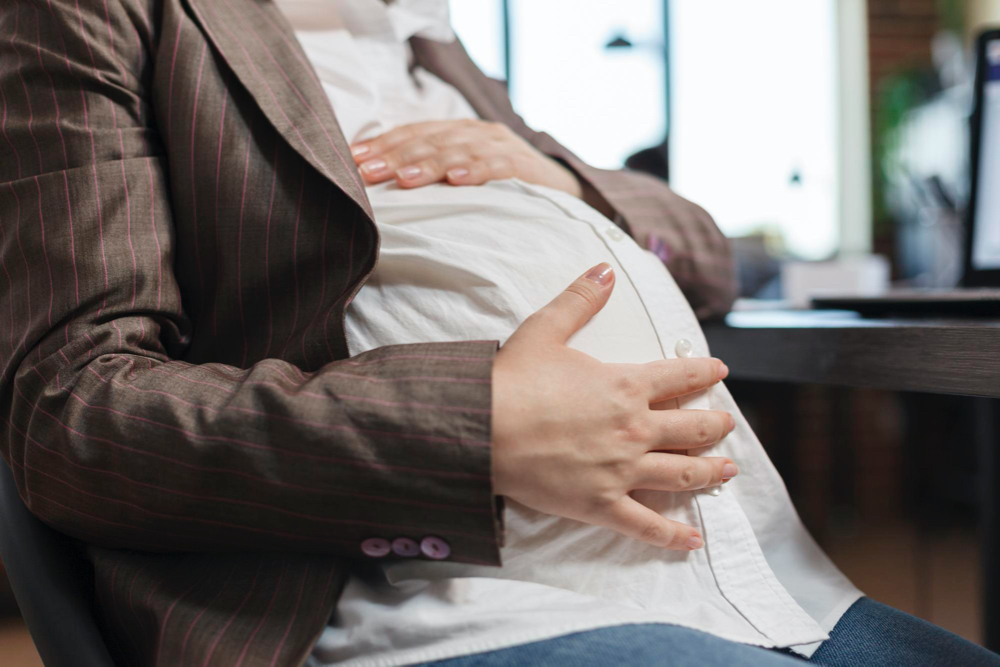 pregnant touching her belly bump