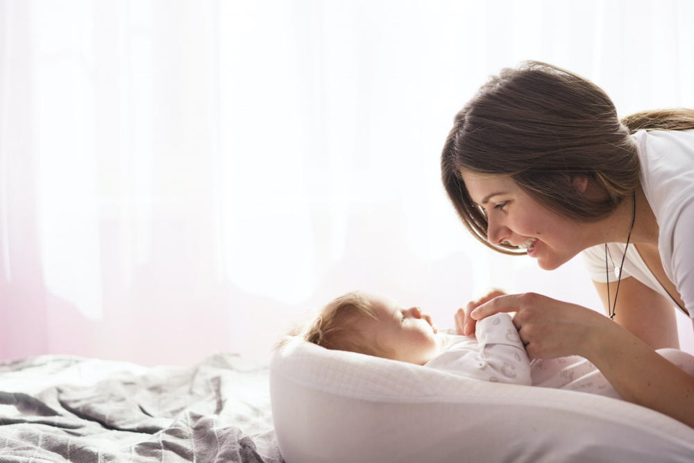 newborn with mom laughing