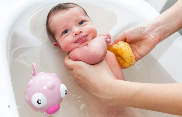 baby smiling while taking a bath