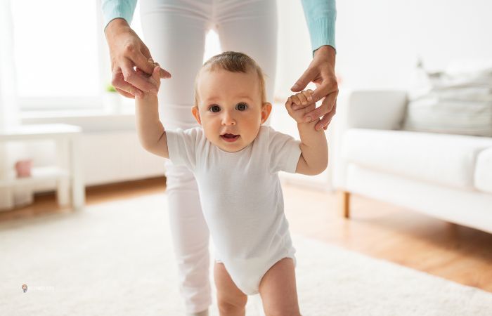 baby walking with mom support