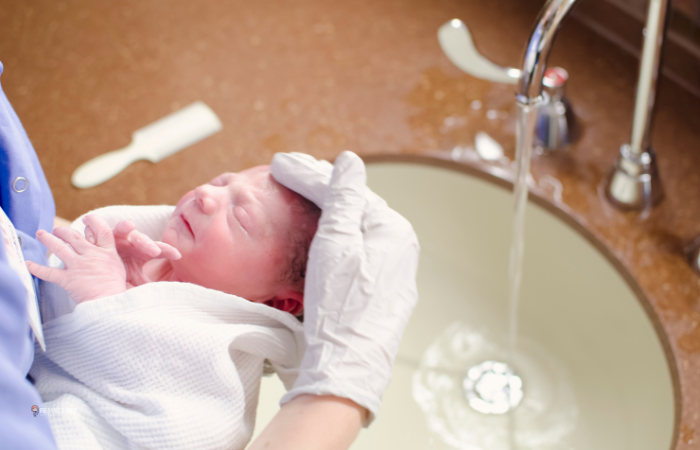 sponge dry bathing a newborn